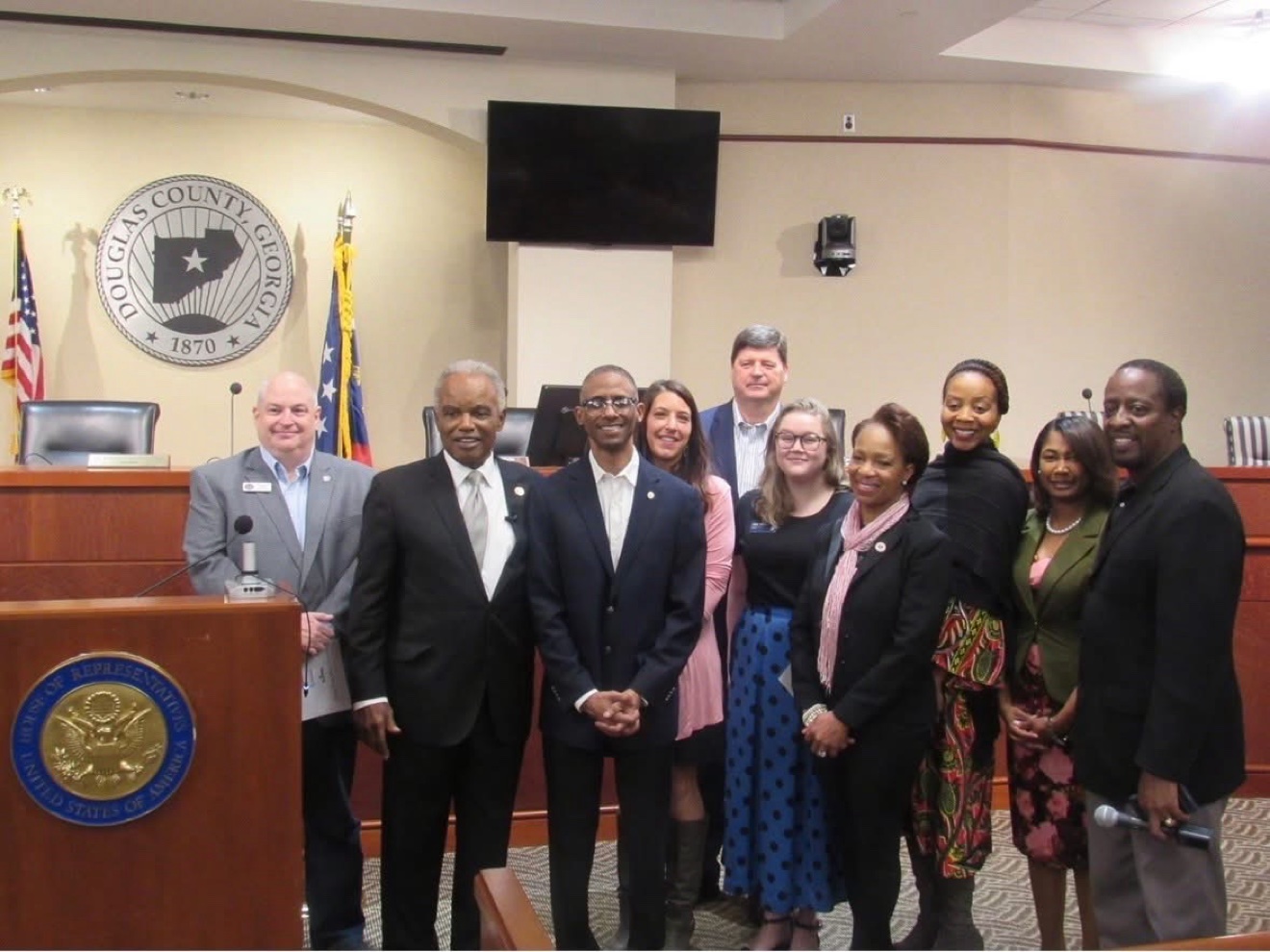 Commissioner Mitchell with county leaders at the commission podium