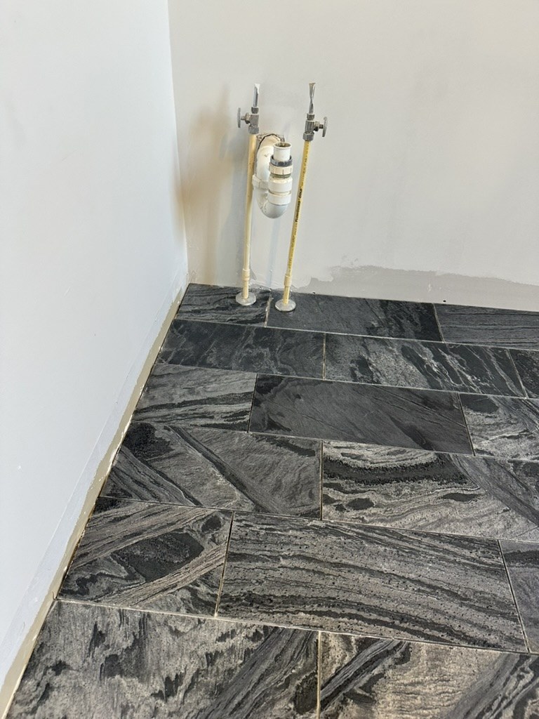Sink plumbing on the new tile floor