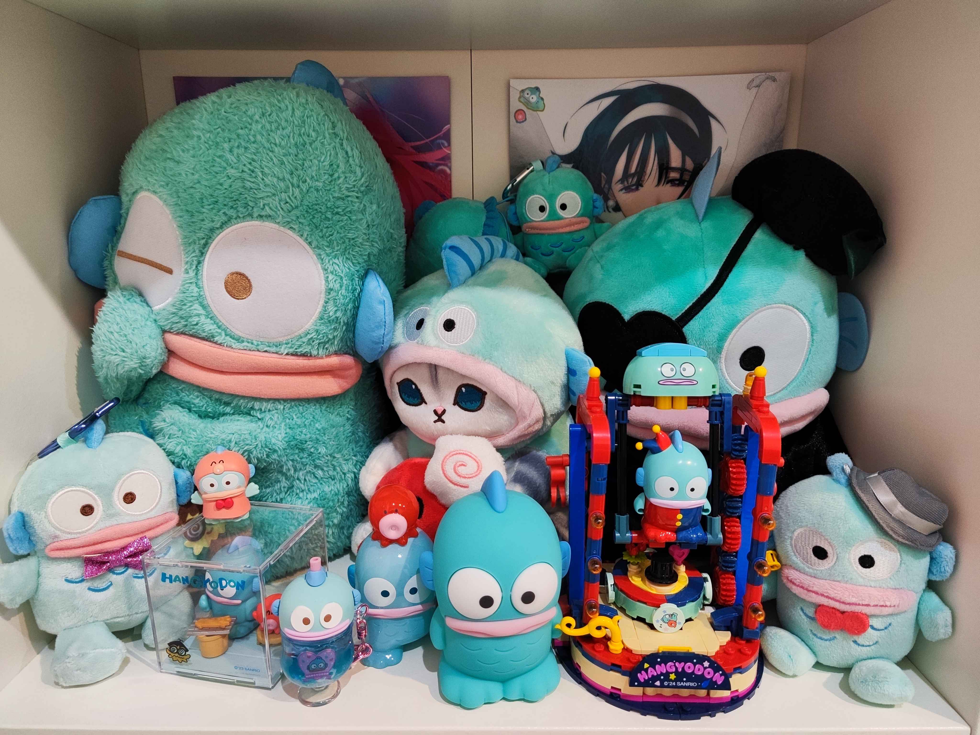 my main shelf, featuring mizisua. i put hangyodon stickers on sua's poster so she doesn't seem too out of place.