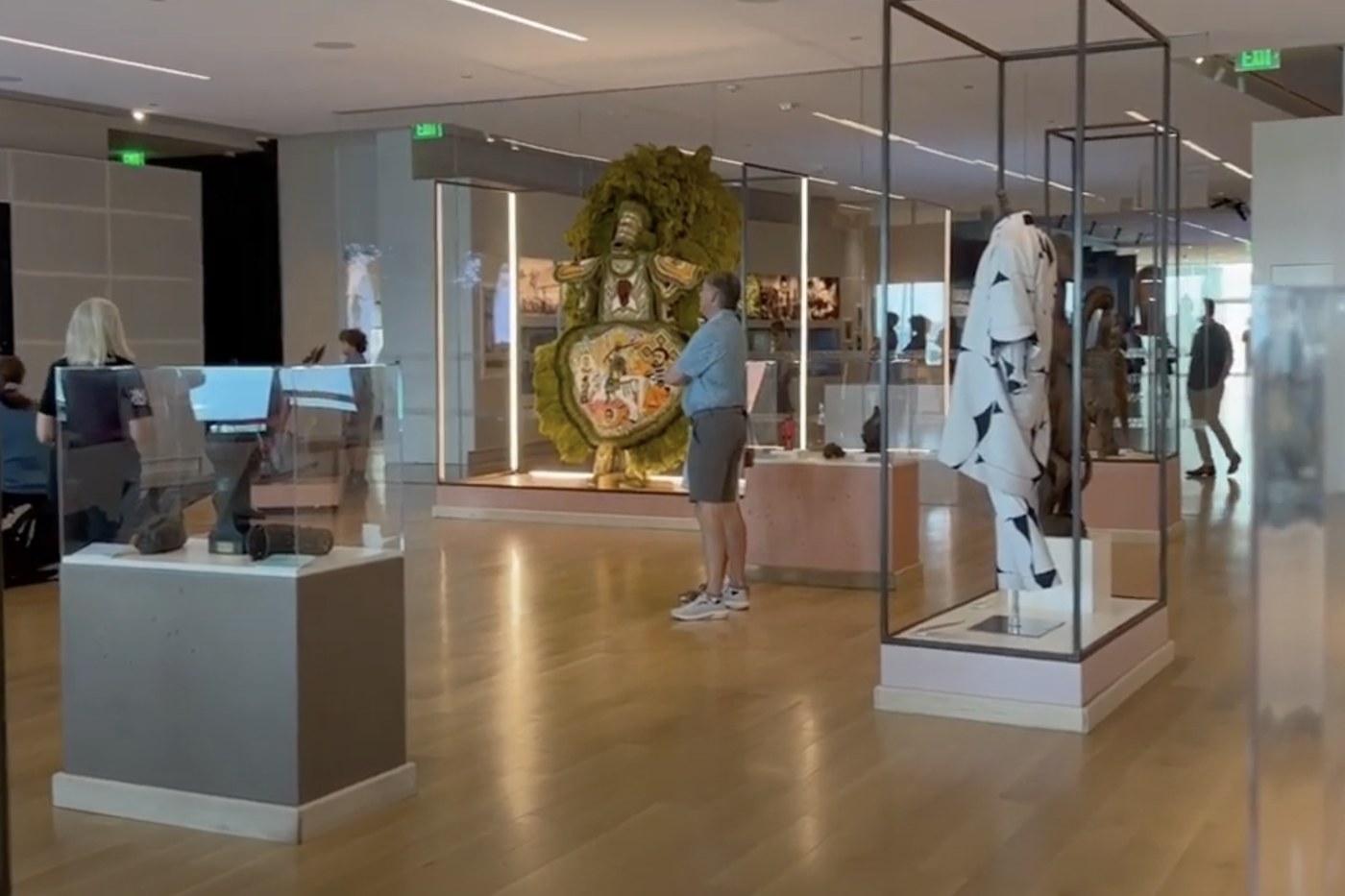 A wide gallery inside Charleston's International African American Museum with exhibition displays and visitors.