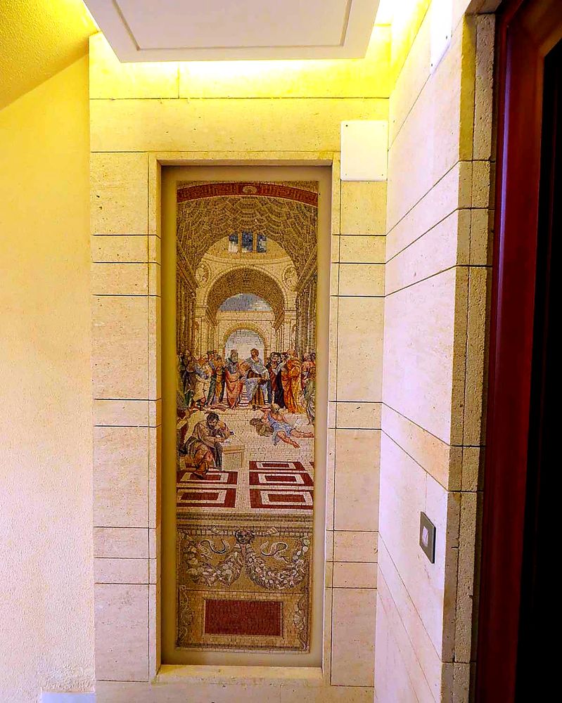 Grand commercial lobby floor mosaic medallion, showcasing intricate natural stone craftsmanship for a luxurious entrance.