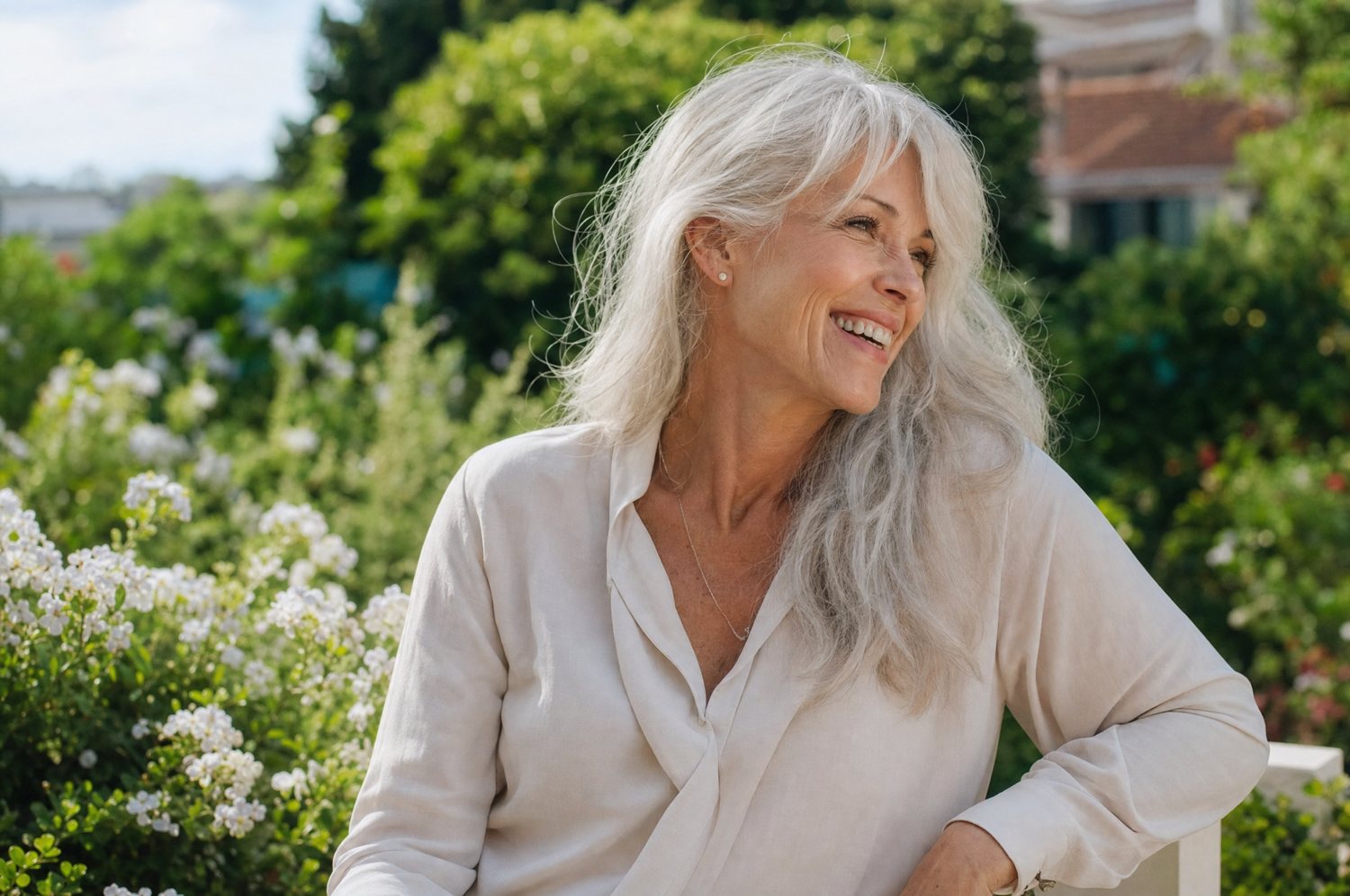 An older woman laughing outdoors