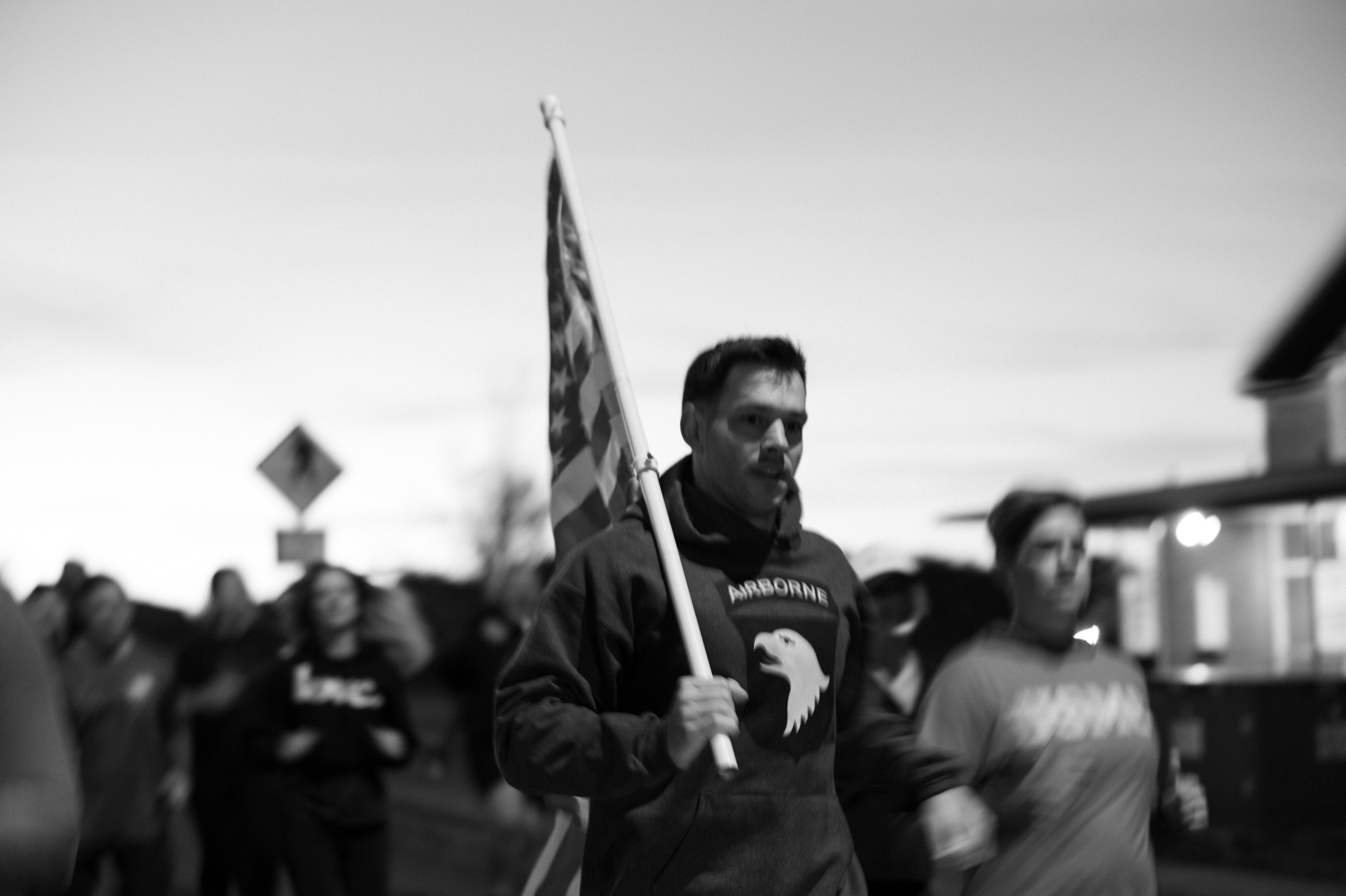 Runners marching with the American flag