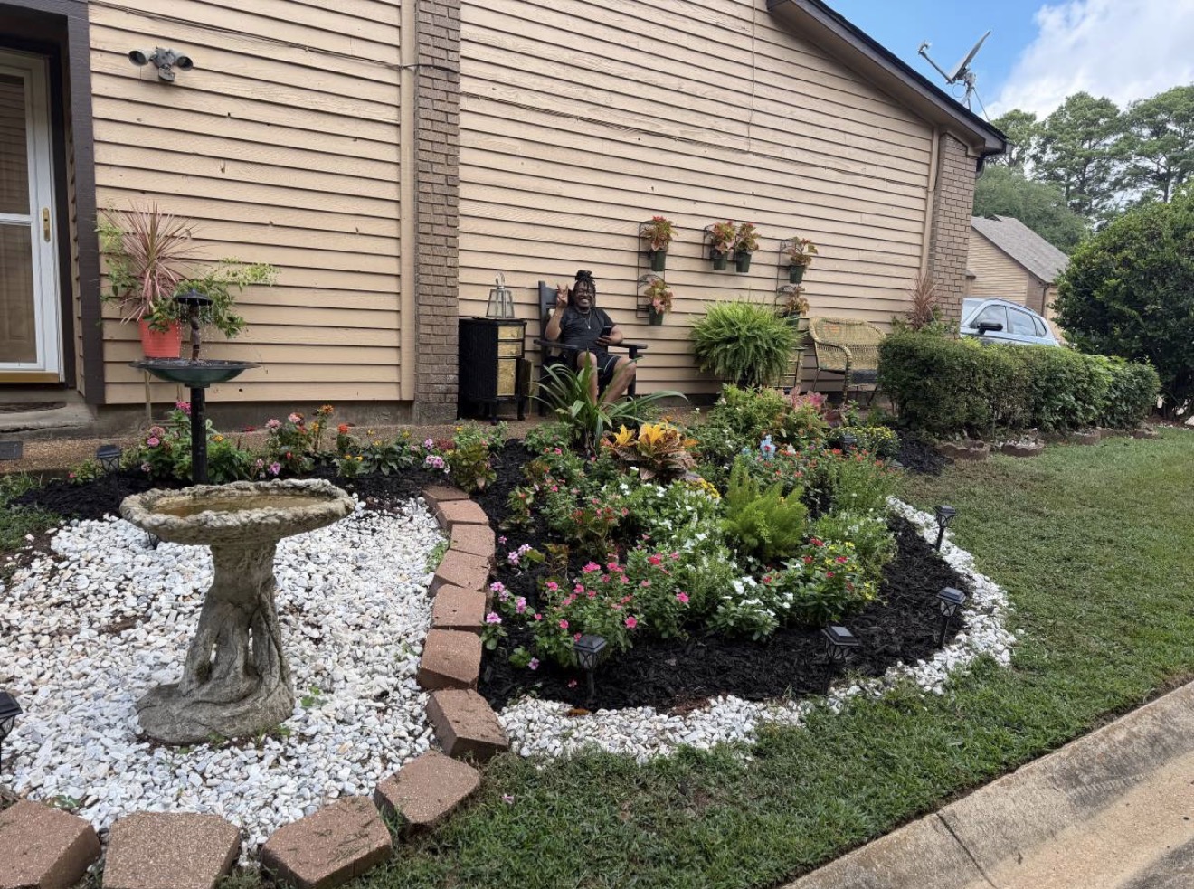 Neatly trimmed hedge row beside the lawn and flower bed