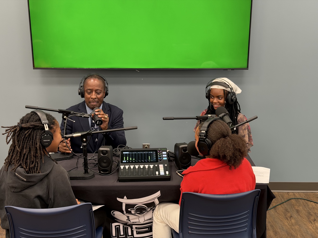 Commissioner Mitchell recording a podcast with young community participants
