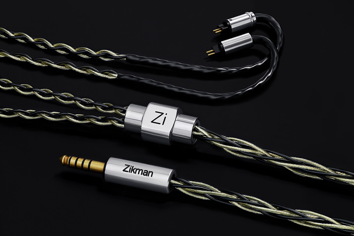 Multiple braided IEM cables with Zi metal splitters on a dark background