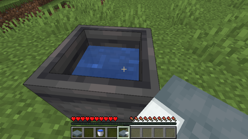 A patterned cushion being used beside a water-filled cauldron