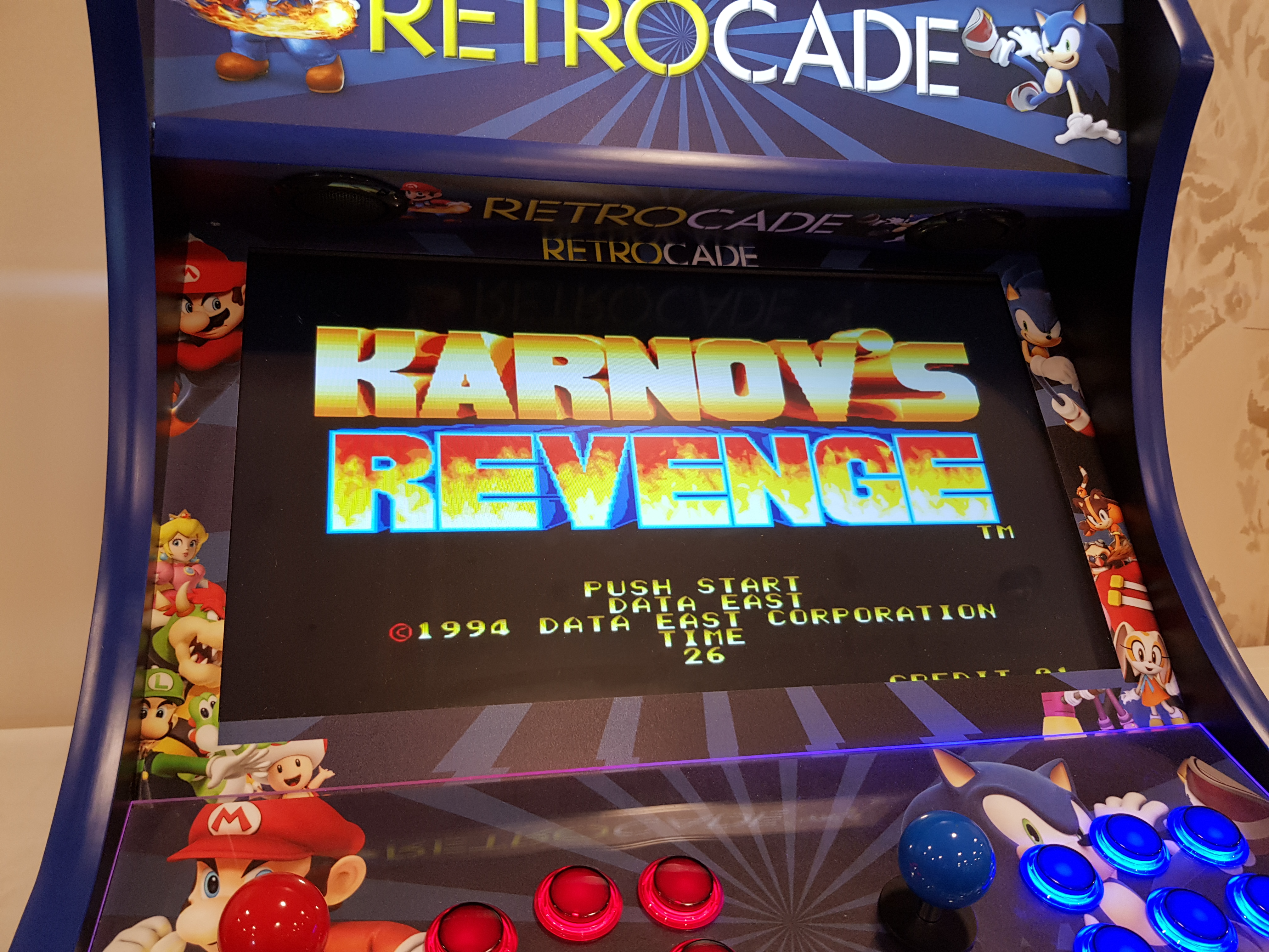 A bartop arcade cabinet displaying the Karnov's Revenge title screen