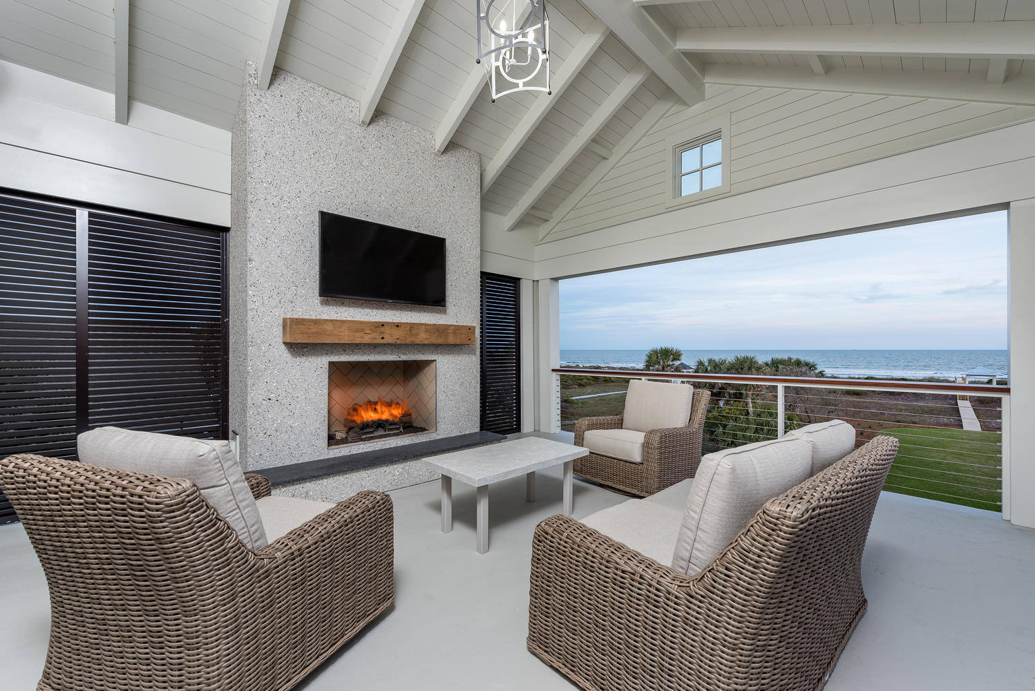 Covered porch with fireplace and ocean view