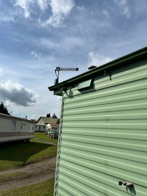 Modern CCTV camera installed on a UK residential property wall overlooking the driveway
