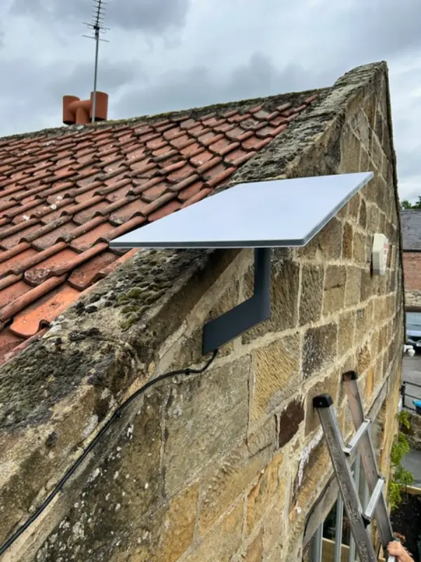 Outdoor PoE security camera being installed by a professional engineer using a drill
