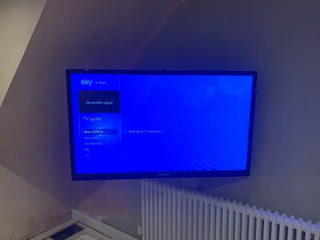 Wireless security camera setup with solar panel on a UK garden shed