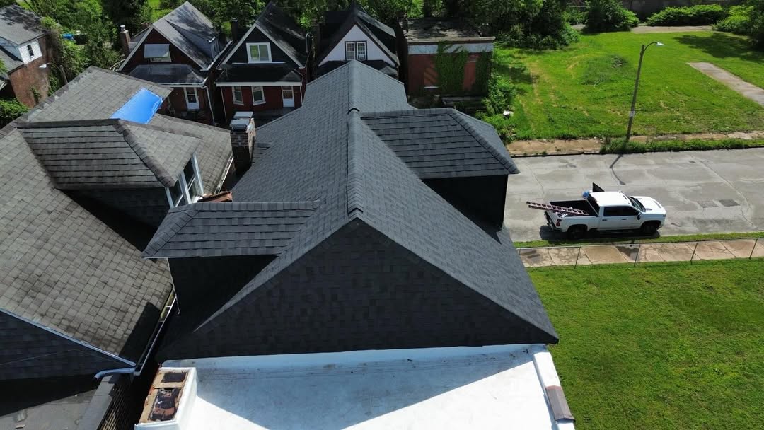 Completed dark shingle roof from above