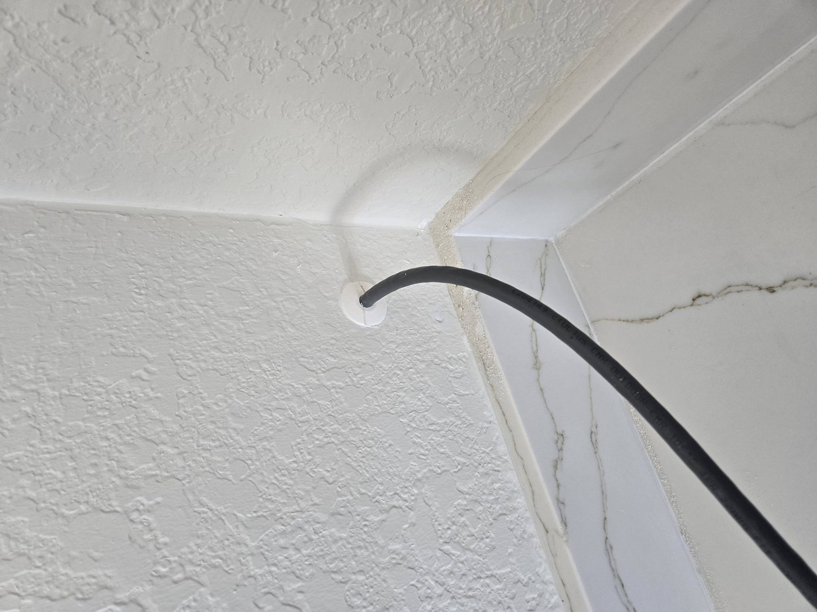 Clean cable routing through an interior wall