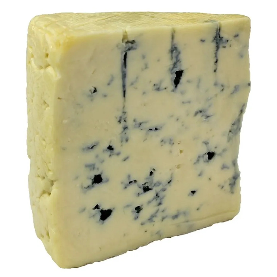 a piece of CréMonté cheese having a yellow color and blue veins