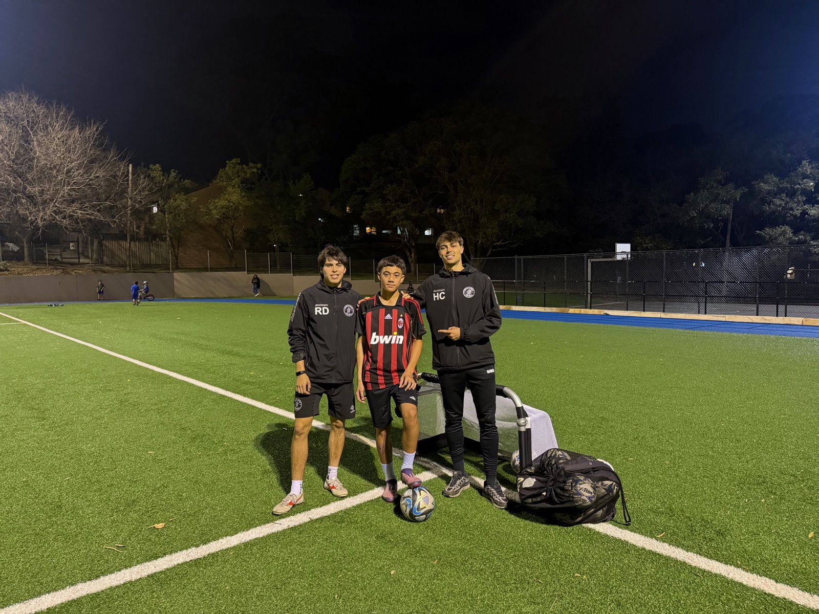 Coaches Ryan and Hugo with one of their CD Football players on the pitch