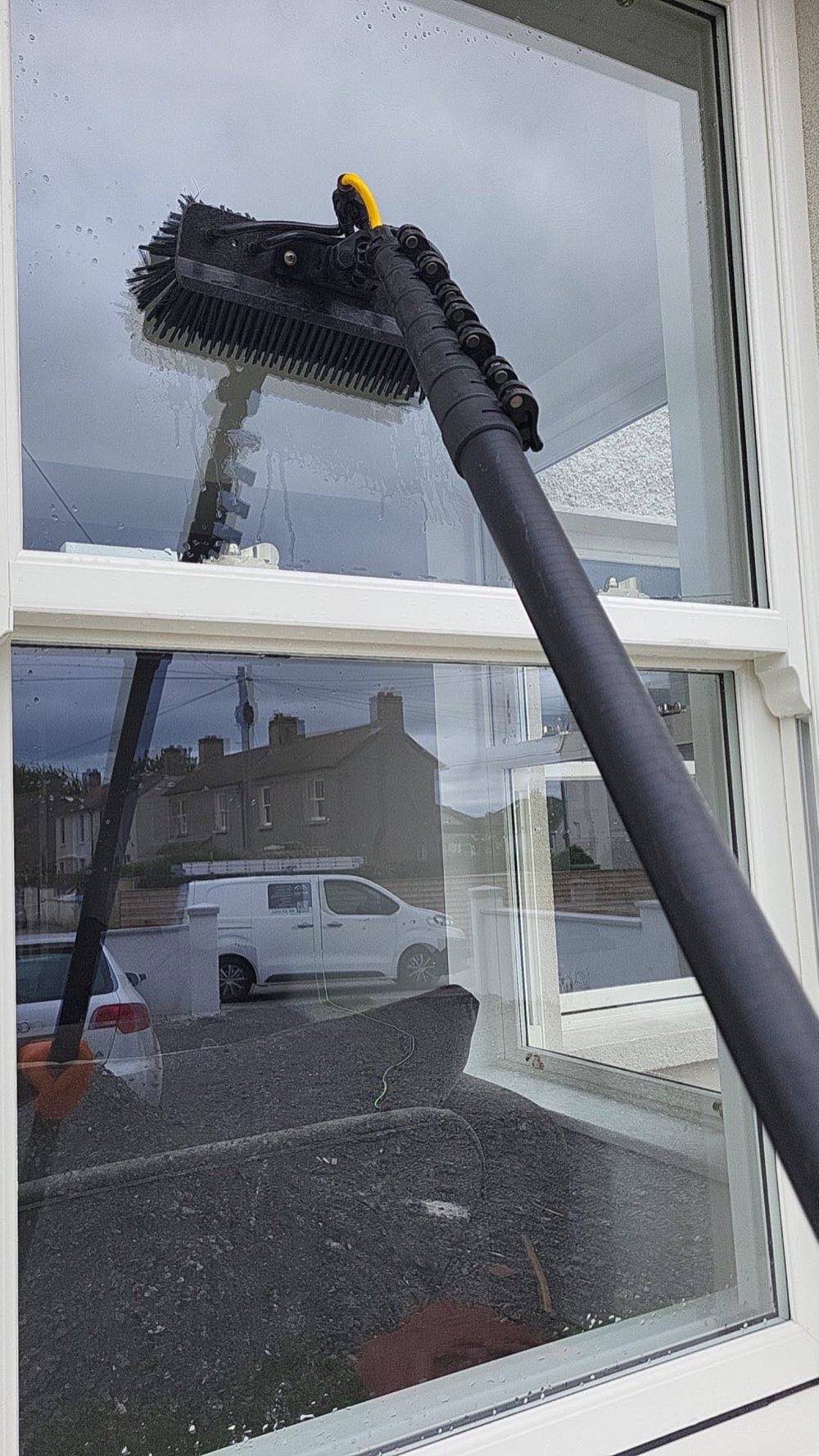 Water-fed pole cleaning a window, first-person view