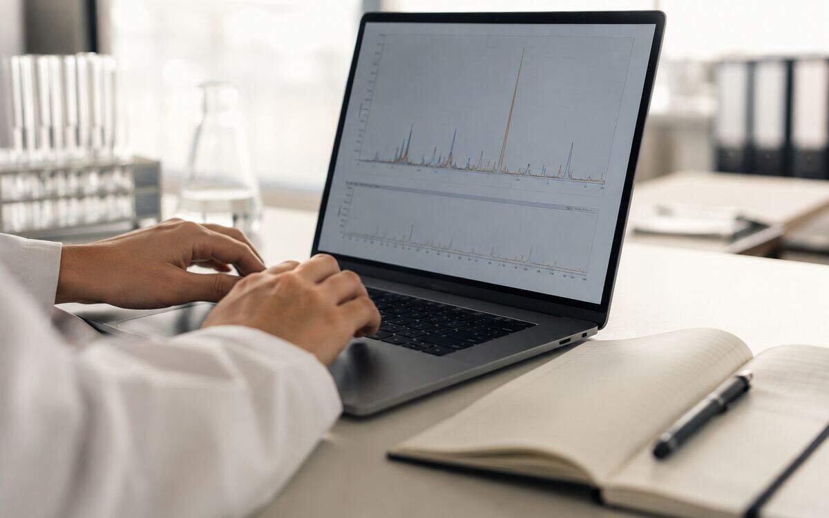 Researcher reviewing chromatogram data on a laptop—Premier Line Research