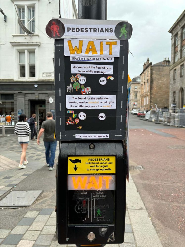 Pedestrian light prototype installed on a Glasgow street, with sticker voting