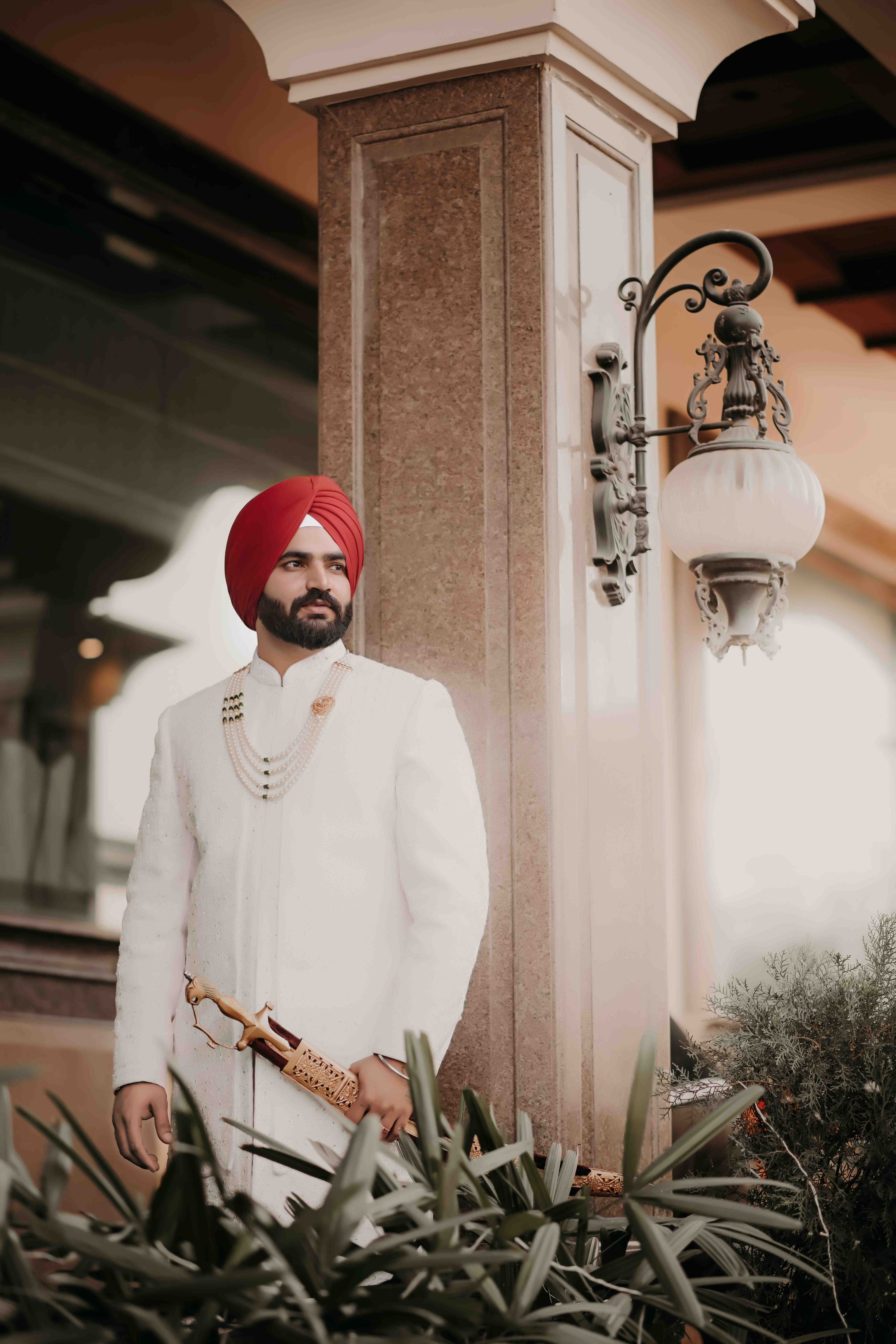Groom — Indian groom in cream sherwani and turban on a decorated white mare during baraat, Groom Portraits by Helloweddingfilms, Best Wedding Photography in Ludhiana