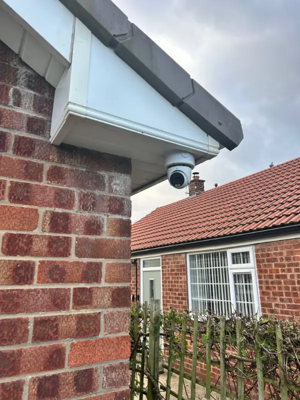 Outdoor PoE security camera being installed by a professional engineer using a drill
