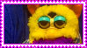 a stamp of a jester furby looking mildly displeased