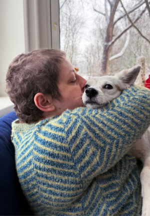 Woman hugging dog with a smushed face