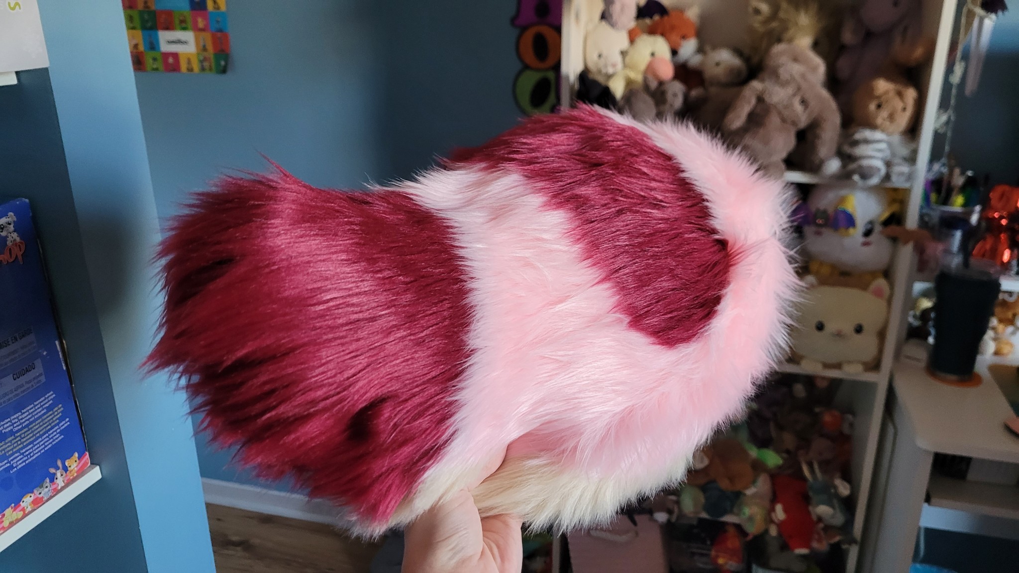 The back of the pink, red and beige fursuit nub tail