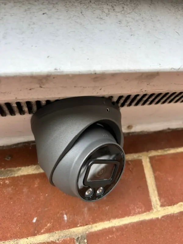 PTZ security camera panning across a warehouse or commercial loading bay