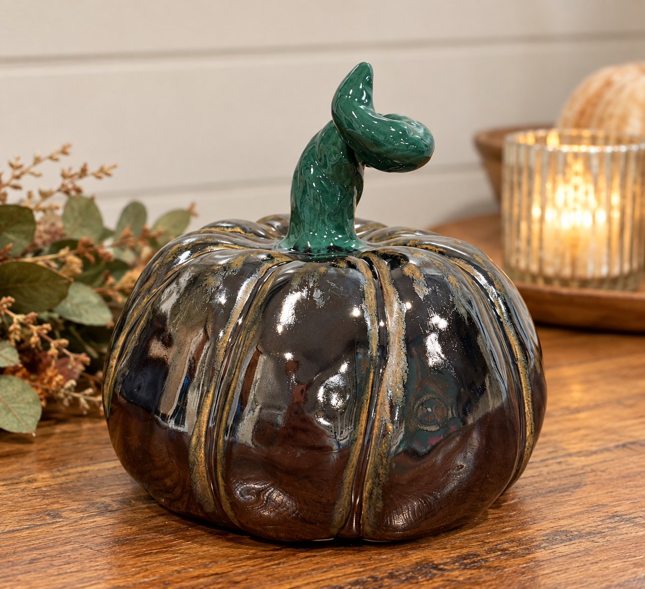 Hand-built pumpkin in black with hand-painted details.