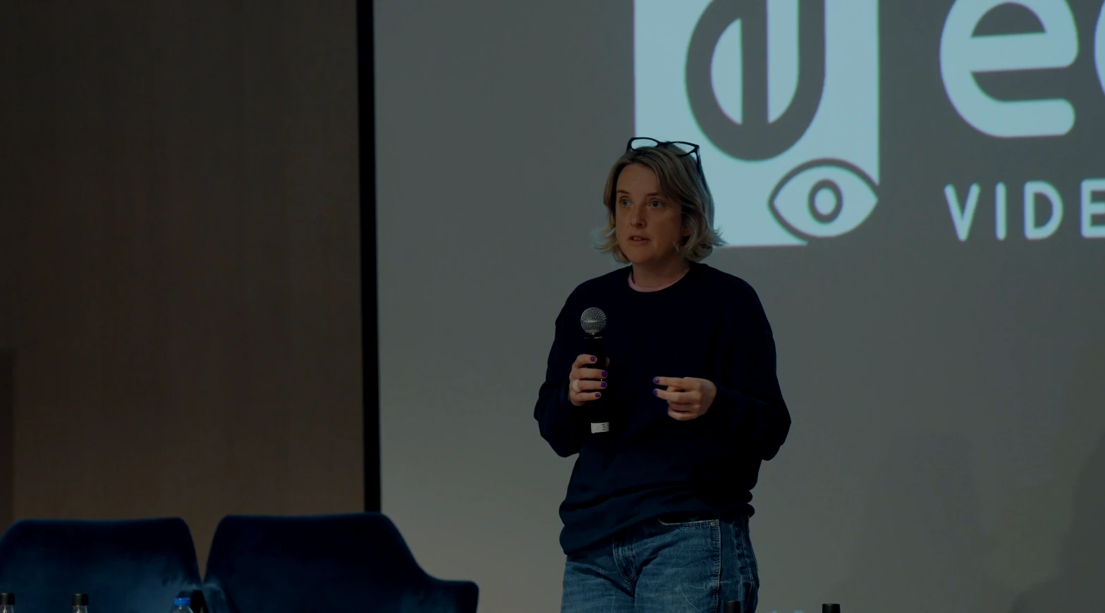 Close shot of a female IFT speaker in a dark sweater speaking into a microphone