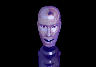 The shiny metallic CGI head of Holosseum's announcer, telling us that it's always great to see guys in good shape