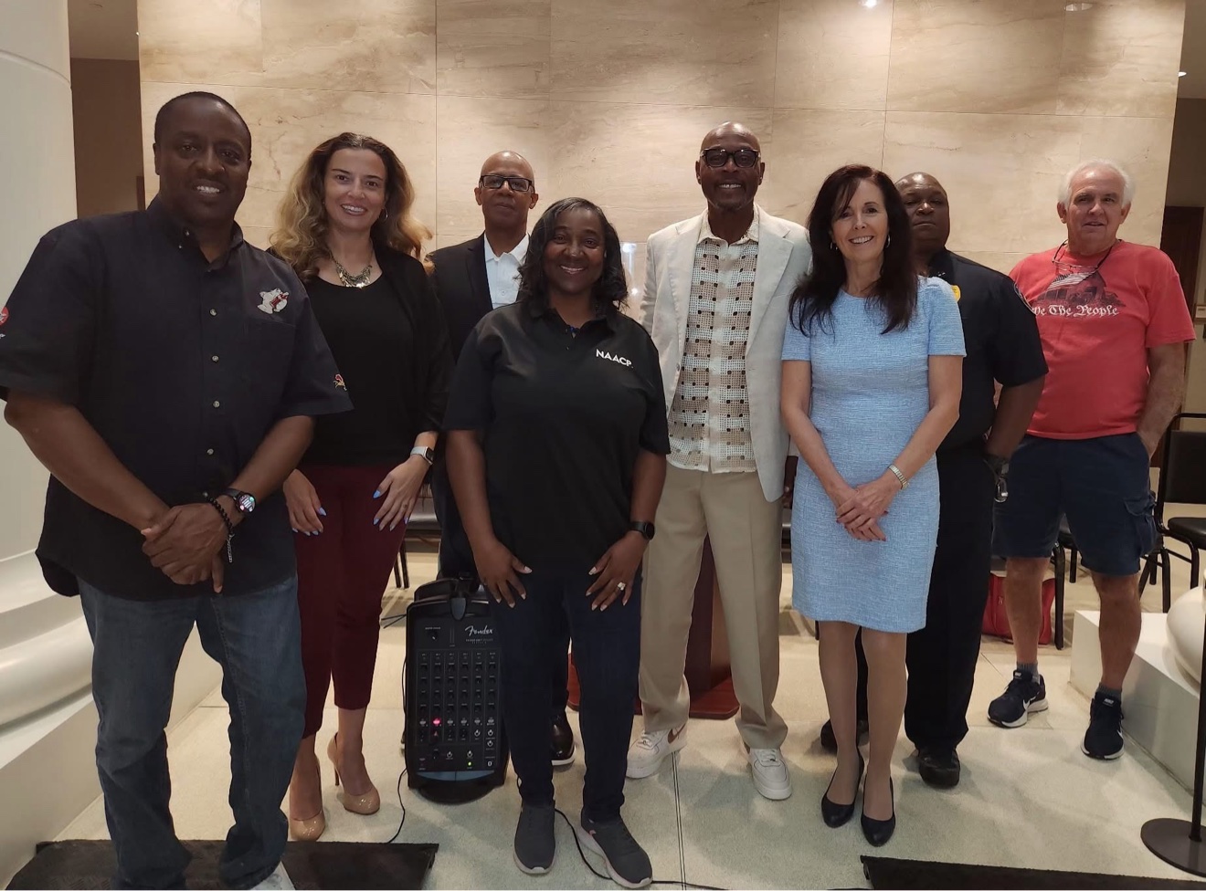 Commissioner Mitchell standing with community leaders at a public event