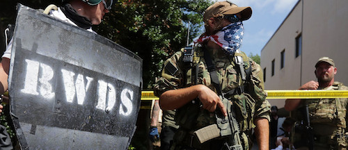 armed militia members "protecting" white supremacists at the 2017 Unite the Right rally in Charlottesville. "RWDS" is an abbreviation of "right wing death squads" a call back to latin-american right-wing groups killing families & vilages with suspected labor and leftist activists - Chip Somodevilla/Getty Images