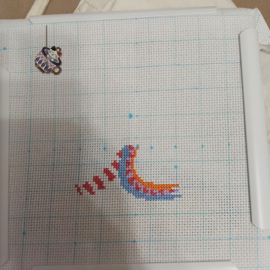 Something that looks like a colourful saddle cross stitch WIP