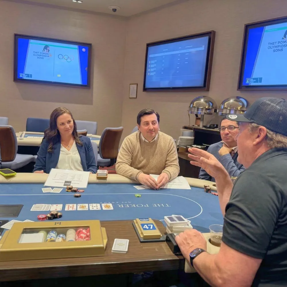 Professional poker player teaching a corporate group at the table
