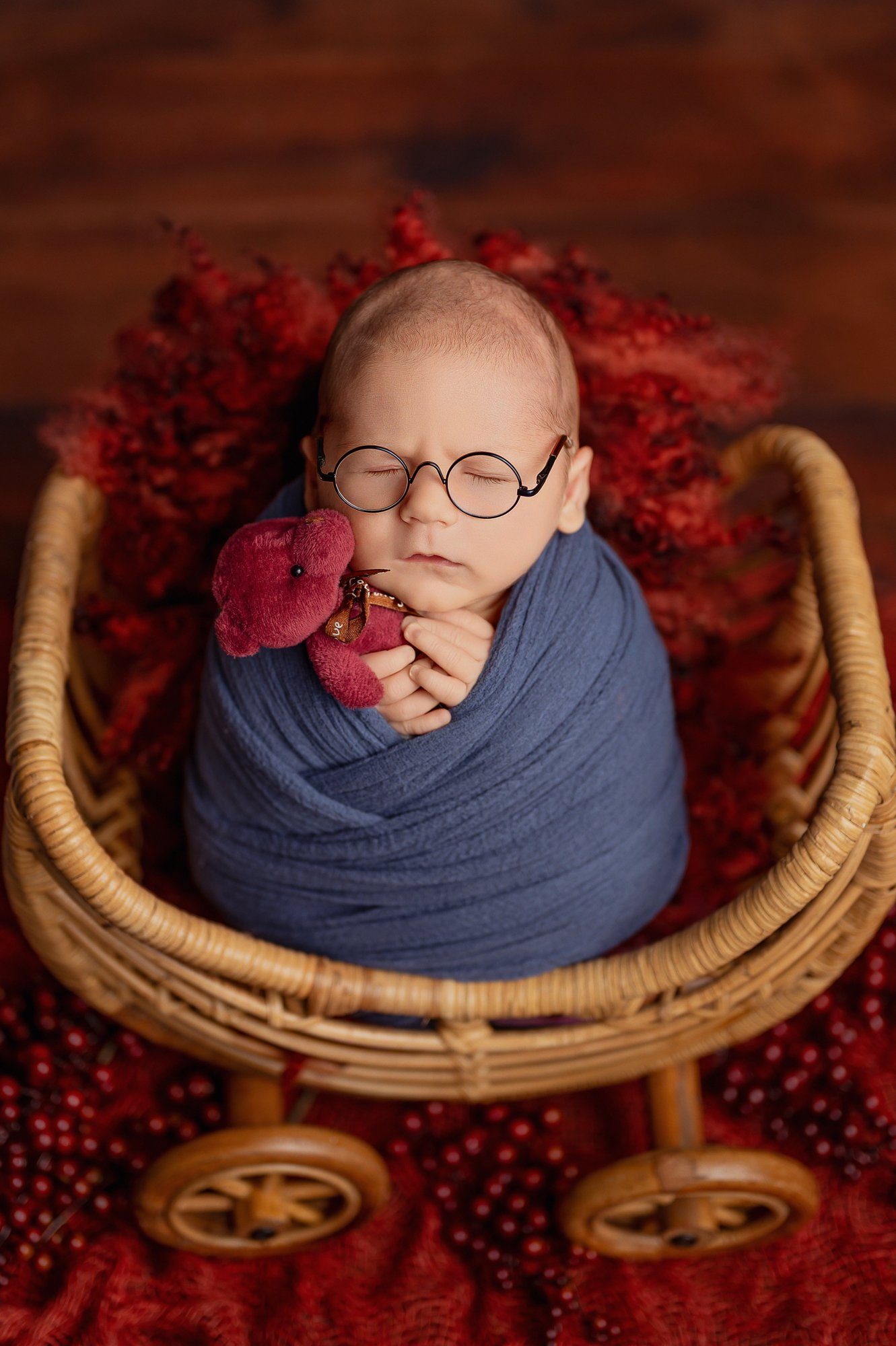 Close-up of newborn photographer's artistic composition with delicate textured wrapping and professional studio lighting