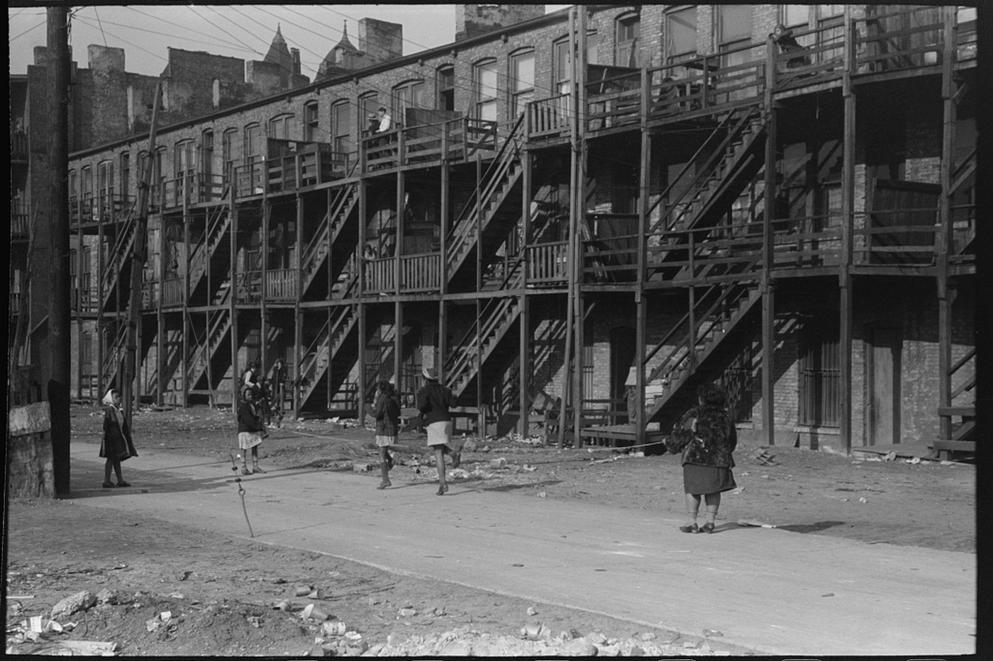 Black residents stand outside multiunit housing in Chicago in April 1941.