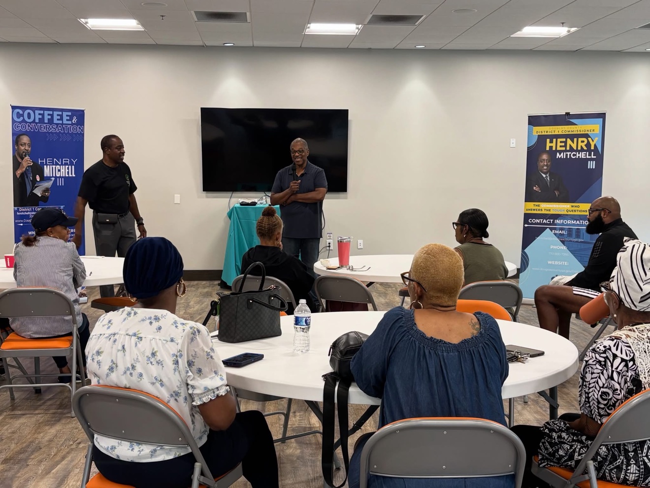A speaker addressing residents at a Coffee and Conversations event