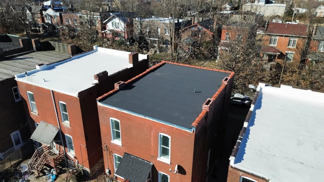 Flat roof repair work on brick building