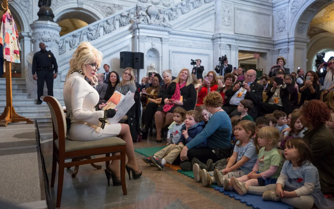 Dolly Parton reading to children in the Library of Congress Great Hall in 2018.