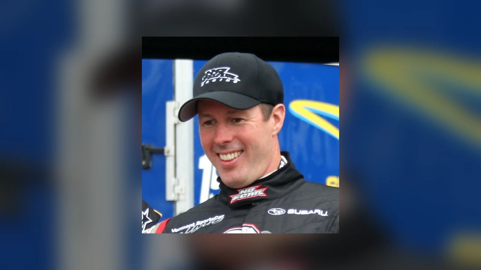 Rally champion Colin McRae smiling in racing gear