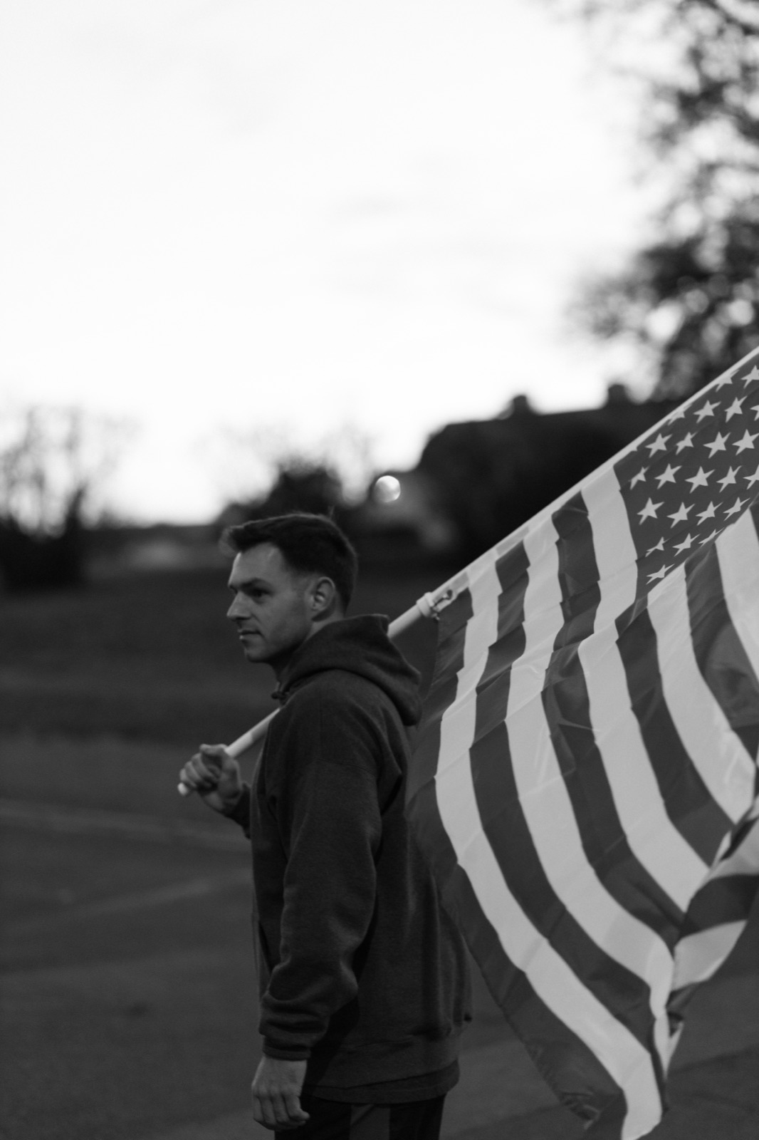 Runner with flag at sunset