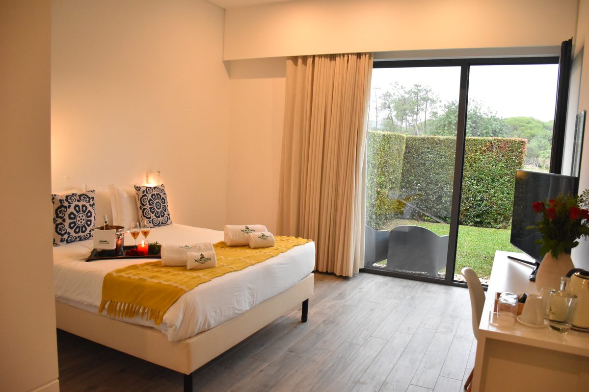 Double Room with Mountain View — bedroom with yellow throw and garden outlook