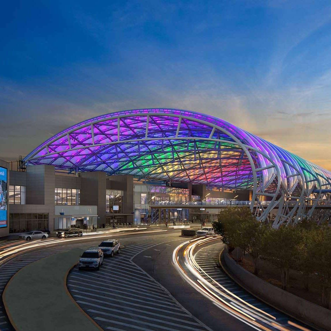 Image of the lit canoopy of the ATL terminal at night.