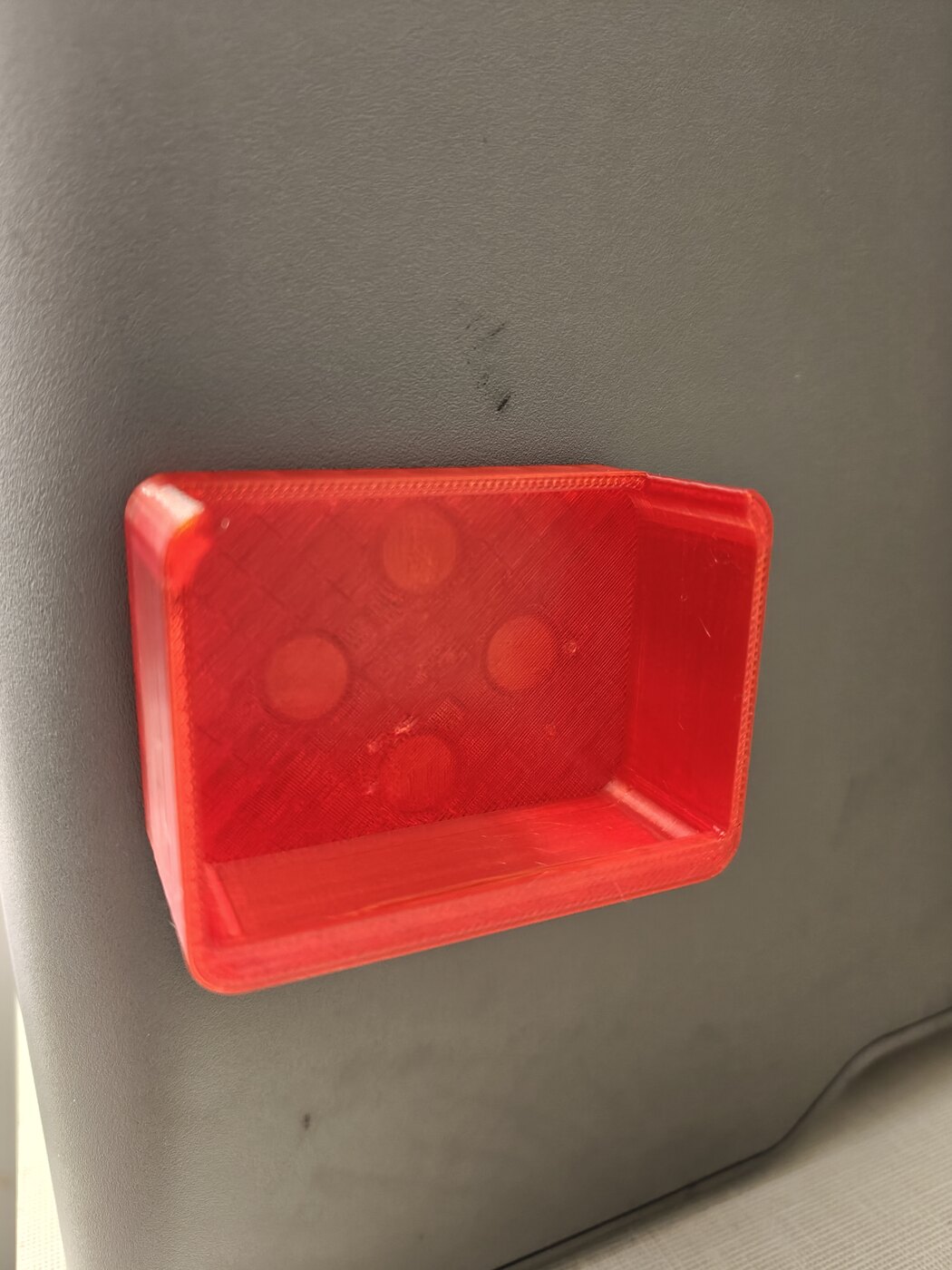 A wide tray snapped to a vertical steel face, its floor magnets visible through the translucent base