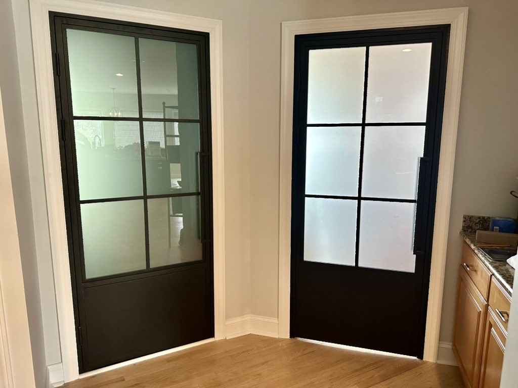 Black-framed glass doors into the laundry room
