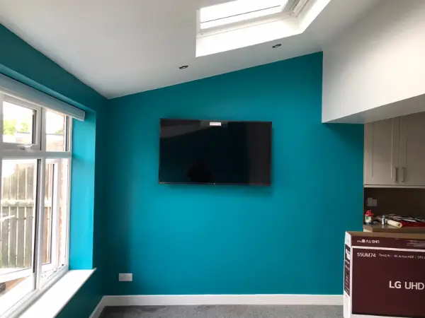 Modern CCTV camera installed on a UK residential property wall overlooking the driveway