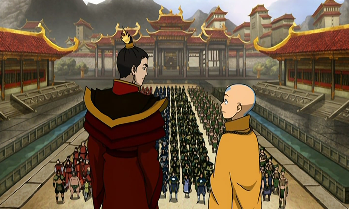 A photo of Aang and Zuko from the final episode of Avatar: The Last Airbender. The two are dressed in ceremonial clothing, and stand in front of a crowd at the royal palace of the Fire Nation.