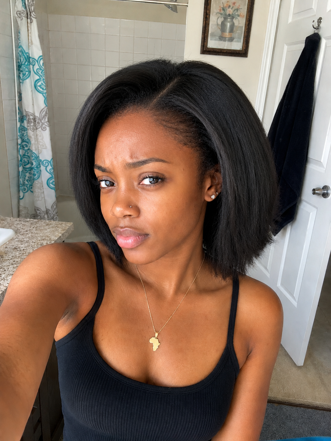 Black woman with sleek glass-straight hair after using the steam brush